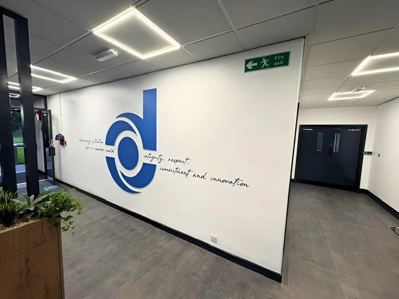 Signs and graphics phase 2: fret-cut foamex Donaldson logo with wall vinyl graphic lettering.